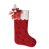 An 18 inch tall handmade wool felt stocking with a scalloped cuff, pom pom, bow, and leaf details