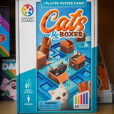 Smart Games 'Cats & Boxes' puzzle game box on a shelf with other games.