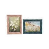 Resin bobbin-style photo frame sized to hold a 5x7 photo, shown in one of two available colors