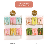 An assortment of six small zippered pouches or charms displayed on two white backing cards labeled FRONT and BACK, with a pink banner at the top reading PRODUCT ASSORTMENT ONLY. The items come in pastel and bright colors including pink, blue, yellow, green, and orange, each with a small gold-tone charm attached.