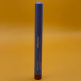 Blue cosmetic stick with 'alleyoop' branding on an orange background