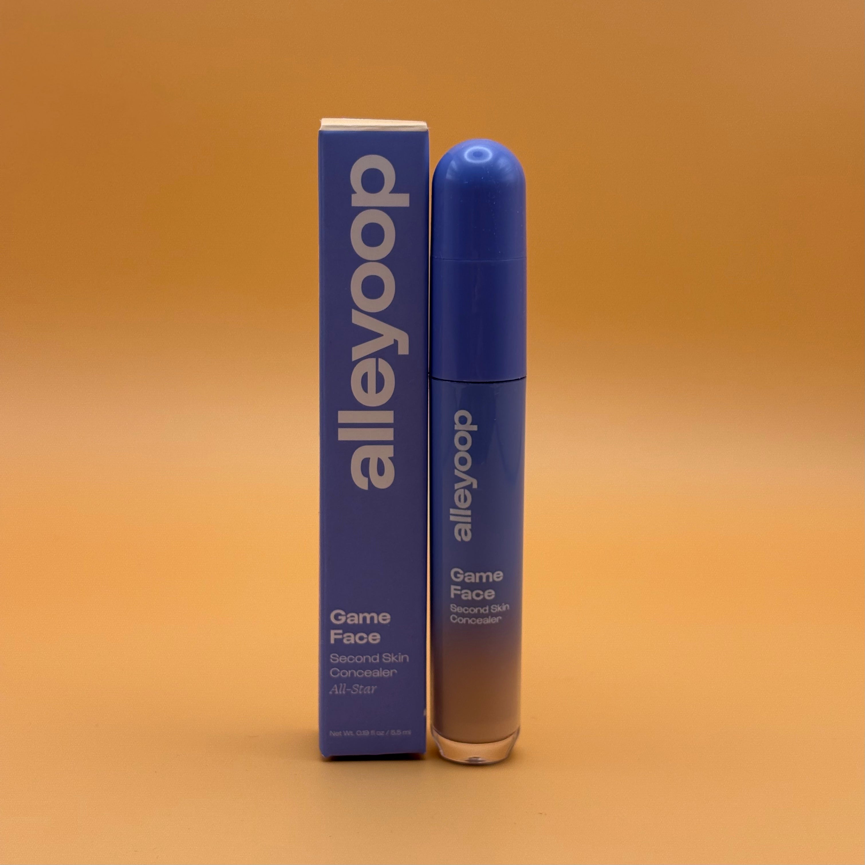 Alleyoop Game Face all star concealer bottle and packaging on a gradient orange background