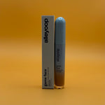 Alleyoop game face concealer champion bottle and packaging on a gradient orange background