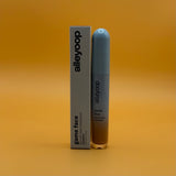 Alleyoop game face concealer champion bottle and packaging on a gradient orange background