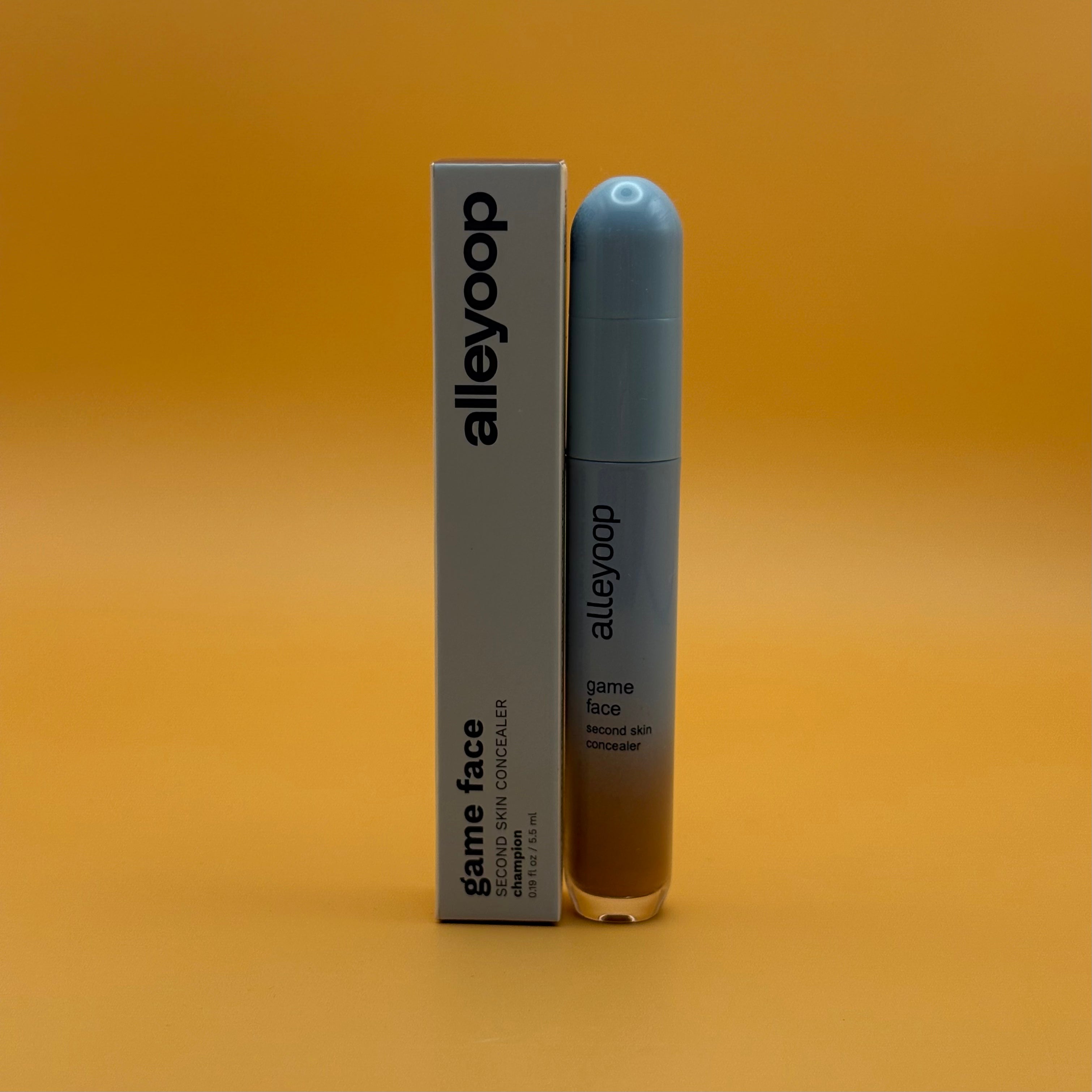 Alleyoop game face concealer champion bottle and packaging on a gradient orange background