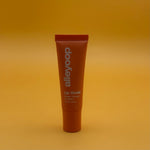 Lip balm tube with 'alleyoop' branding on a yellow background