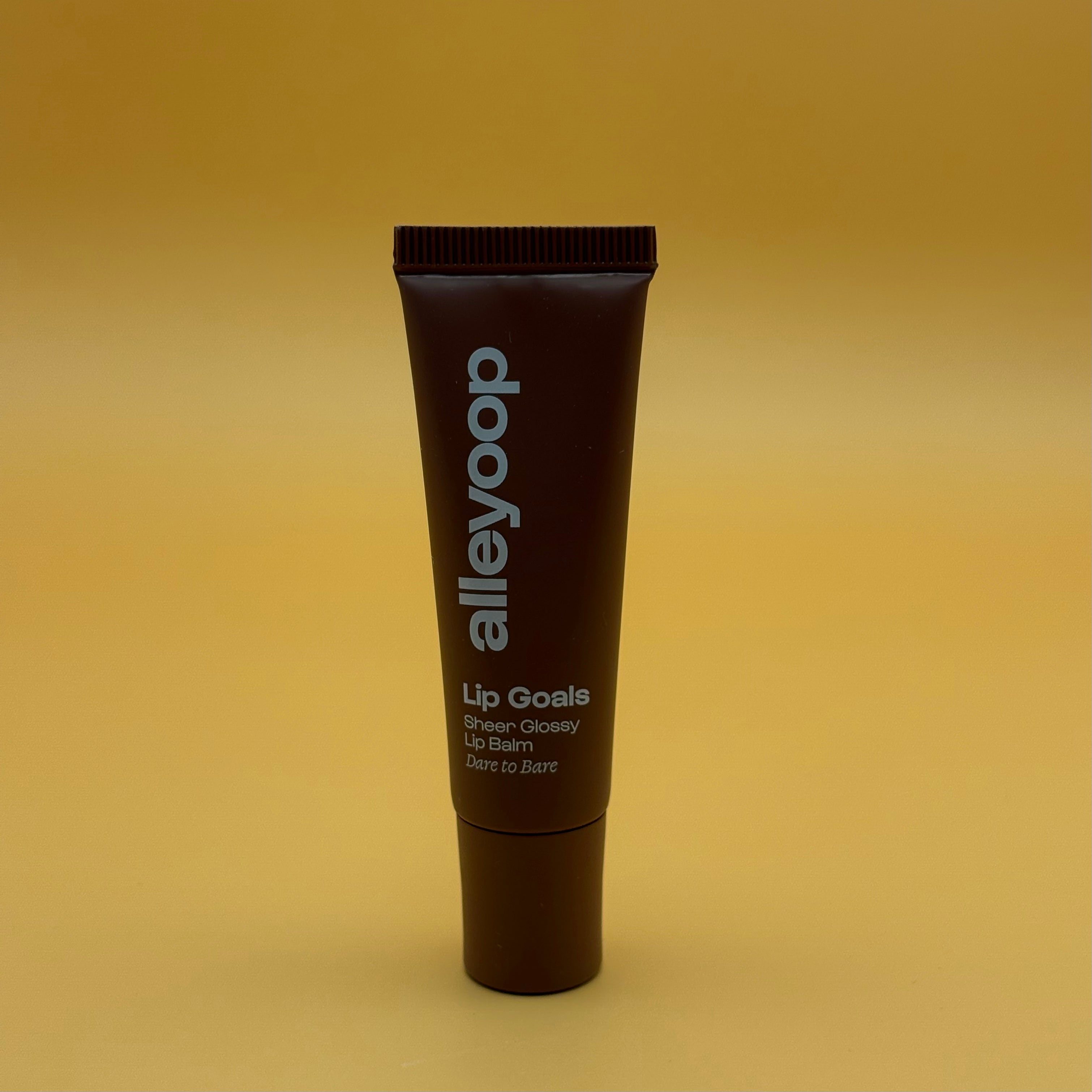 Tube of alleyoop lip balm on a yellow background