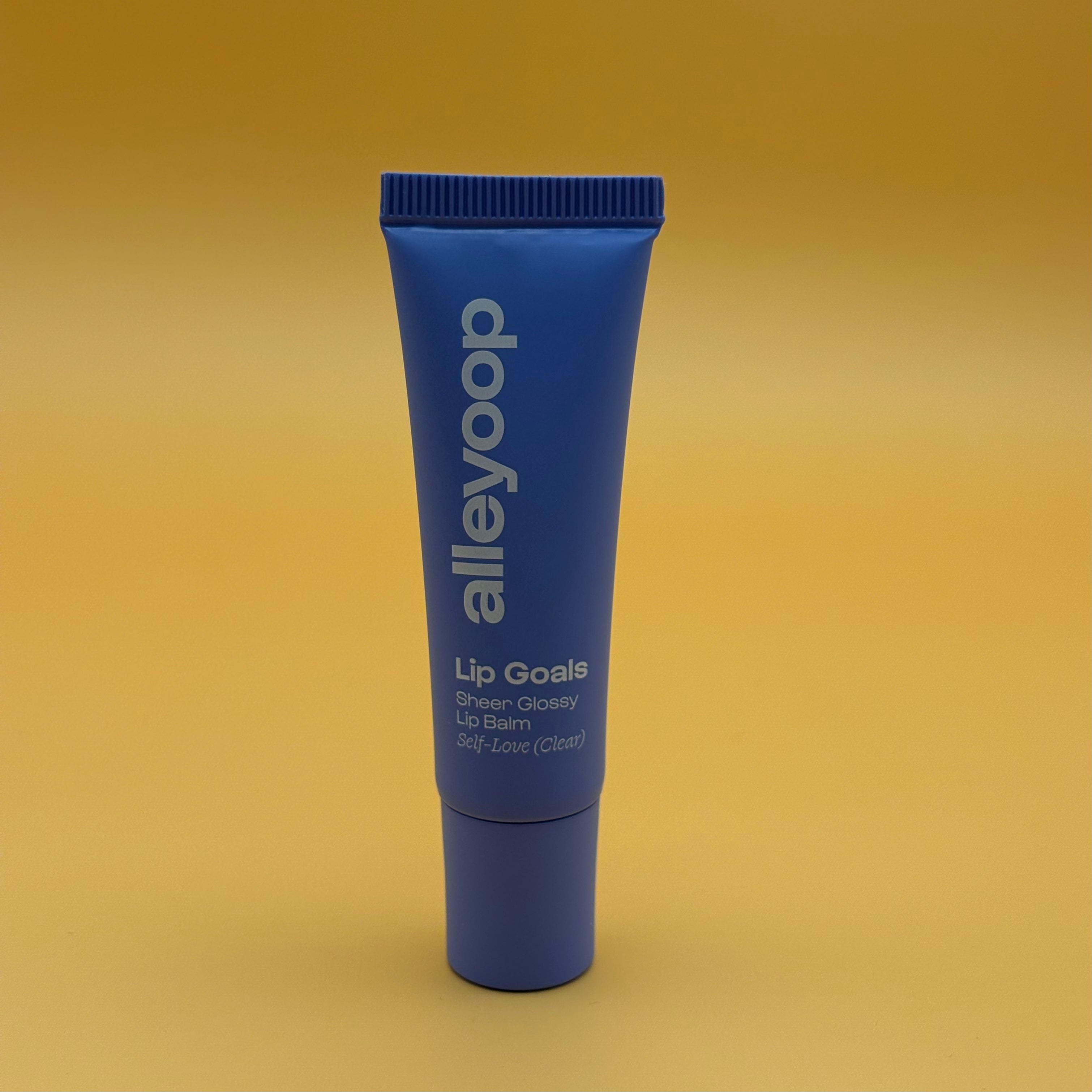 Blue lip balm tube with 'alleyoop' branding on a yellow background