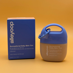 Alleyoop Sun sensational Daily Skin Tint glimmer with blue lid and packaging on a yellow and orange background
