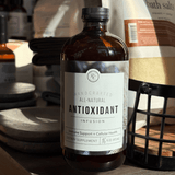 Bottle of Rowe Casa All-Natural Antioxidant Infusion' on a wooden surface with blurred background