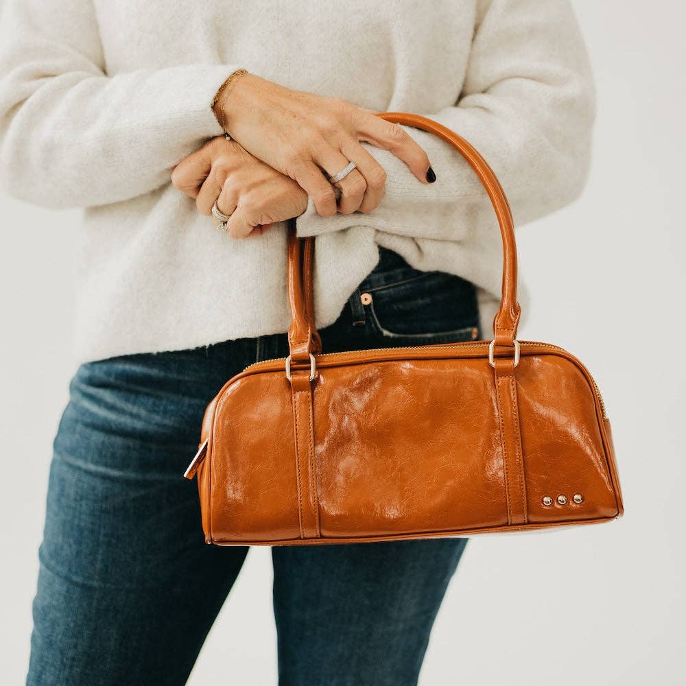 Vegan leather barrel-shaped shoulder bag with an adjustable strap