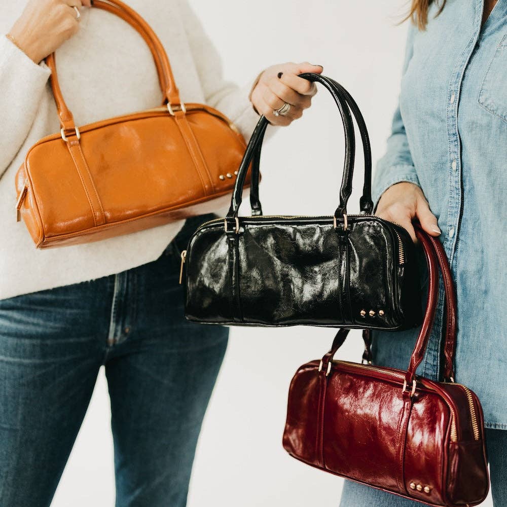 Vegan leather barrel-shaped shoulder bag with an adjustable strap