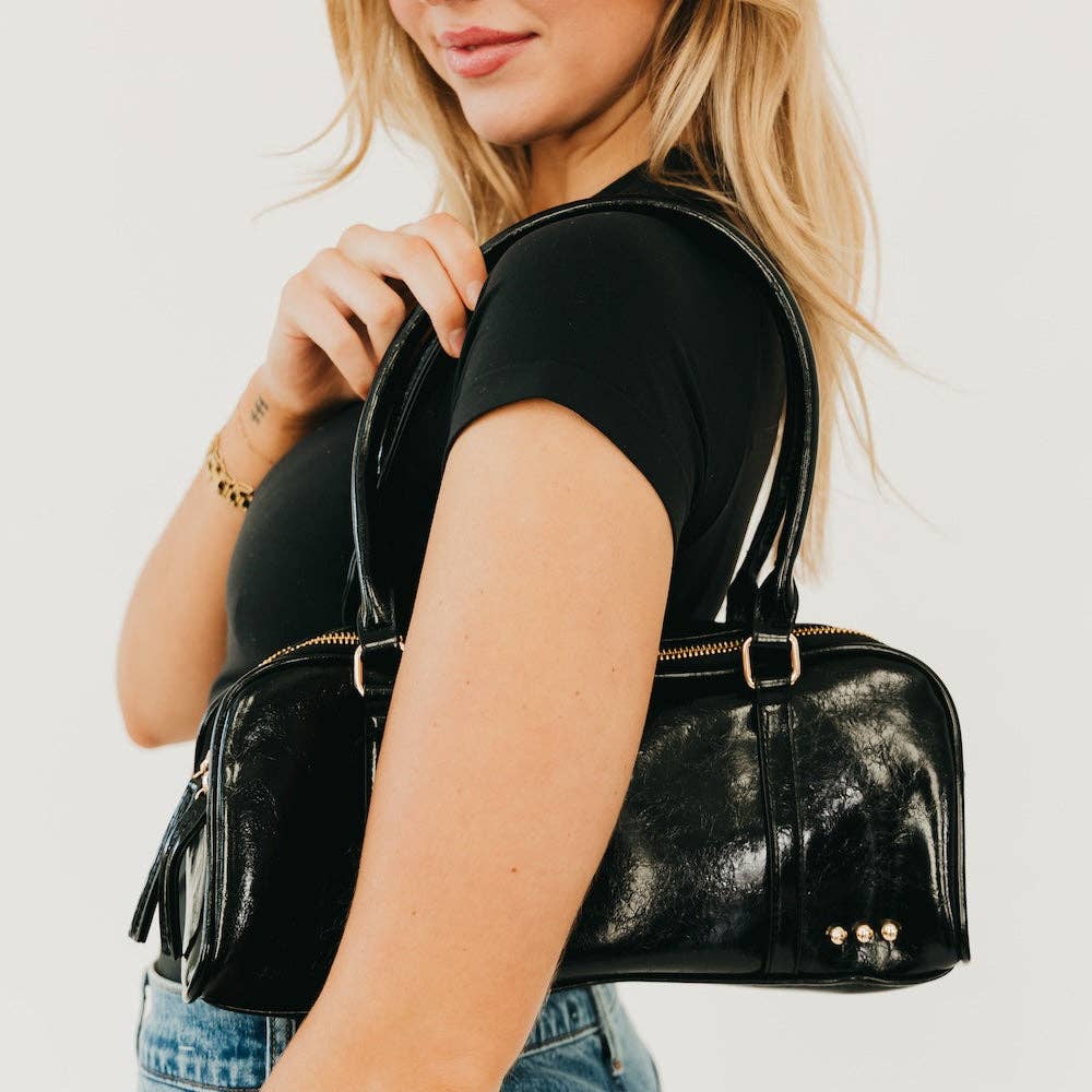 Vegan leather barrel-shaped shoulder bag with an adjustable strap