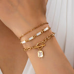 Layered gold-tone necklace with baguette crystals and toggle clasp