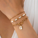 Layered gold-tone necklace with baguette crystals and toggle clasp
