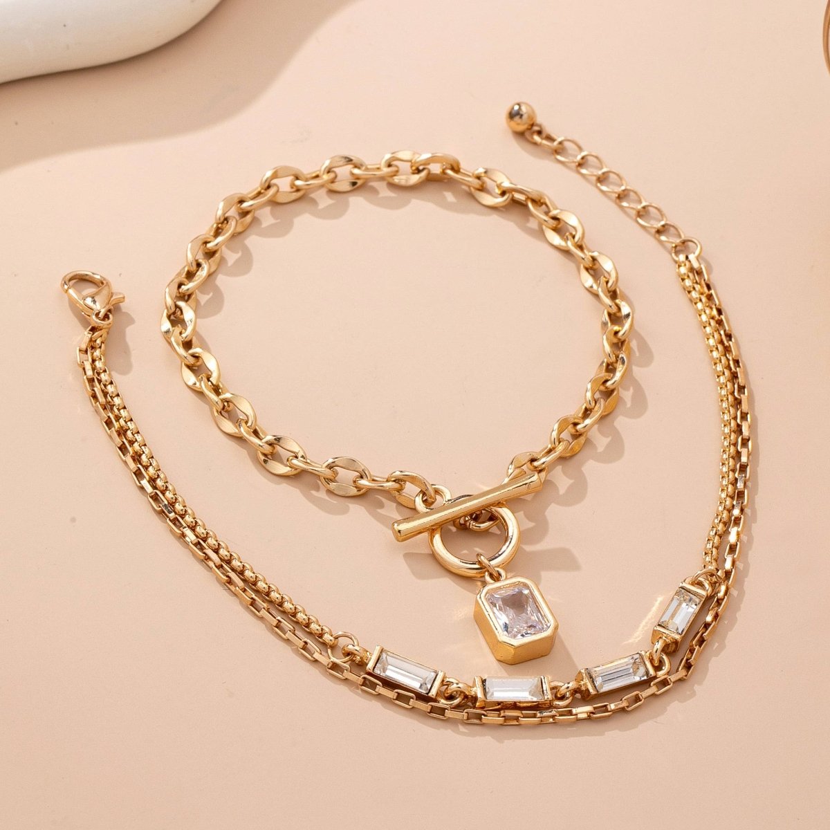 Layered gold-tone necklace with baguette crystals and toggle clasp