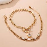 Layered gold-tone necklace with baguette crystals and toggle clasp