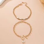 Layered gold-tone necklace with baguette crystals and toggle clasp