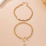 Layered gold-tone necklace with baguette crystals and toggle clasp