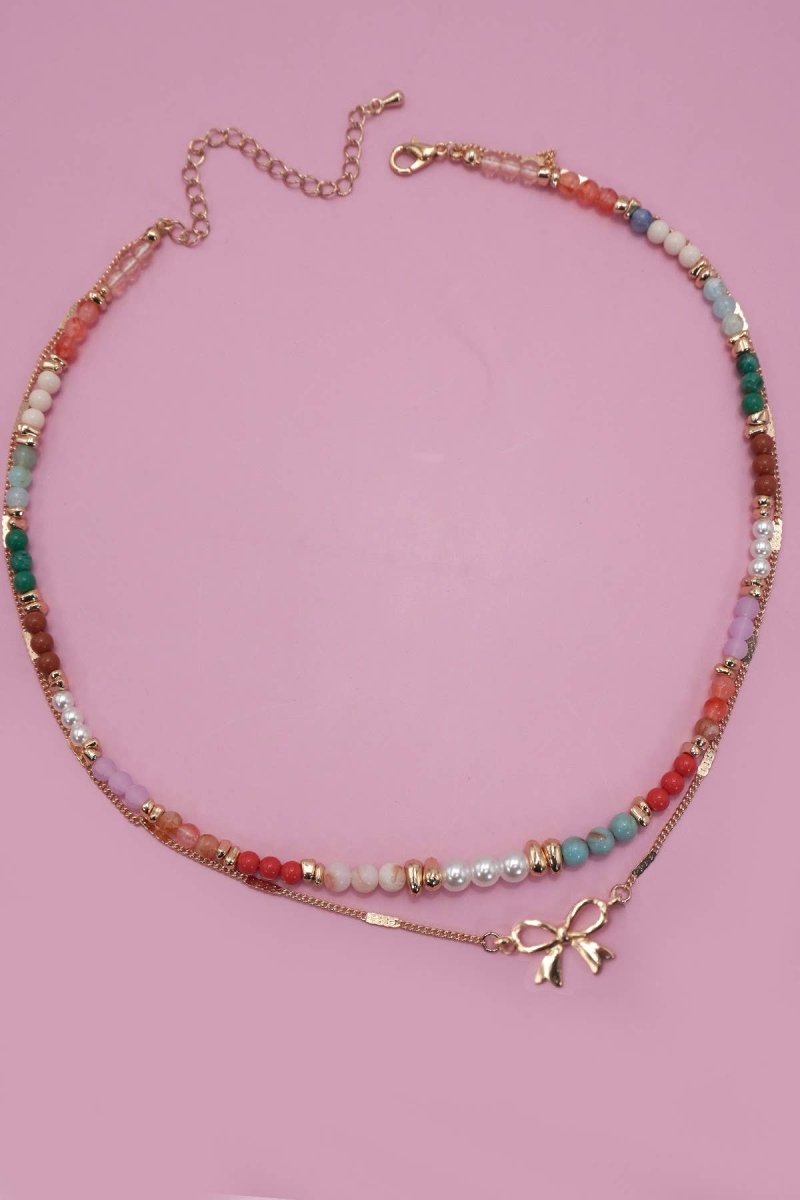Double layer beaded necklace with heart and bow charm