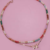 Double layer beaded necklace with heart and bow charm