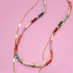 Double layer beaded necklace with heart and bow charm
