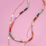 Double layer beaded necklace with heart and bow charm