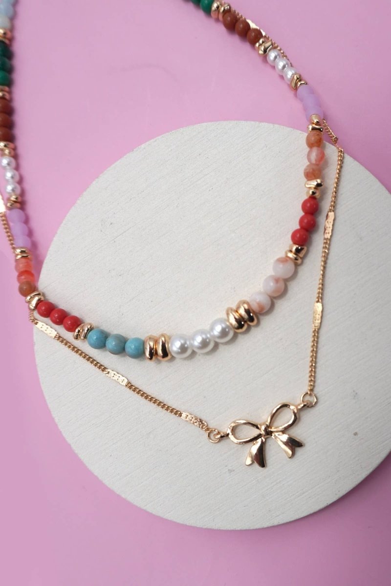 Double layer beaded necklace with heart and bow charm