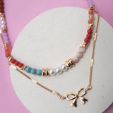 Double layer beaded necklace with heart and bow charm