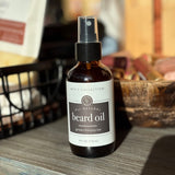 Bottle of all-natural beard oil on a wooden surface with a blurred background