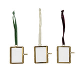 A brass and glass photo frame ornament with a velvet ribbon hanger, one of three colors