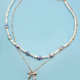 Blue ceramic porcelain pearl necklace with layered bow charm