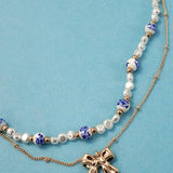 Blue ceramic porcelain pearl necklace with layered bow charm