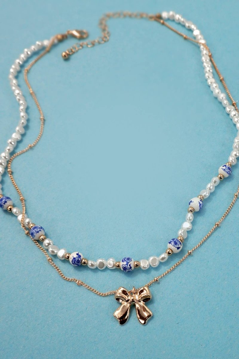 Blue ceramic porcelain pearl necklace with layered bow charm