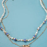 Blue ceramic porcelain pearl necklace with layered bow charm