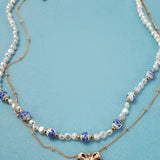 Blue ceramic porcelain pearl necklace with layered bow charm