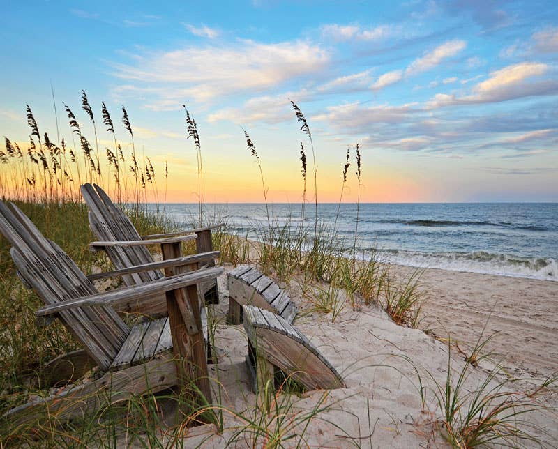 Jigsaw puzzle box for Coastal Sunrise, featuring a pink and gold sunrise over the beach