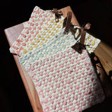 Cotton crocheted pot holders with leather loops in four colors