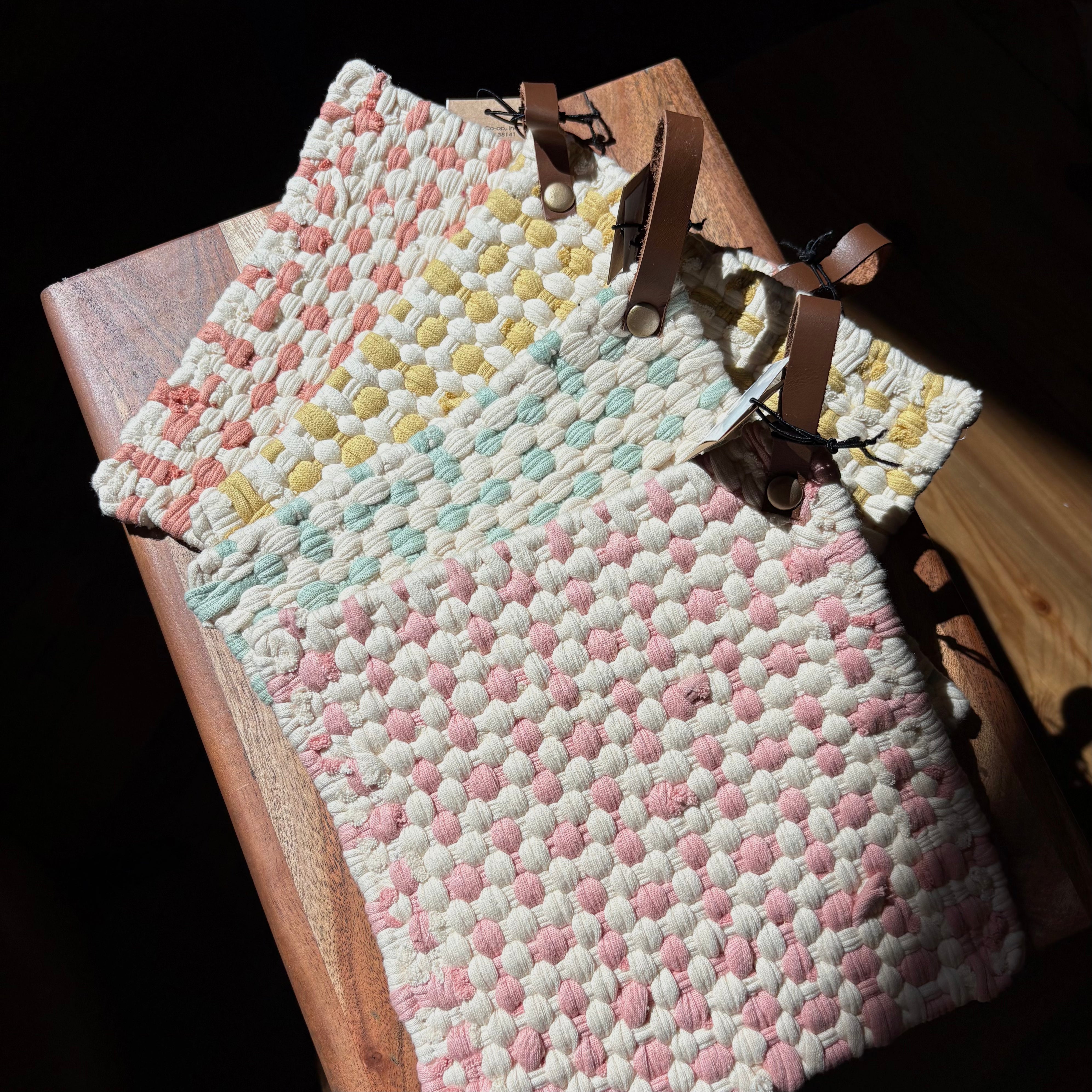 Cotton crocheted pot holders with leather loops in four colors
