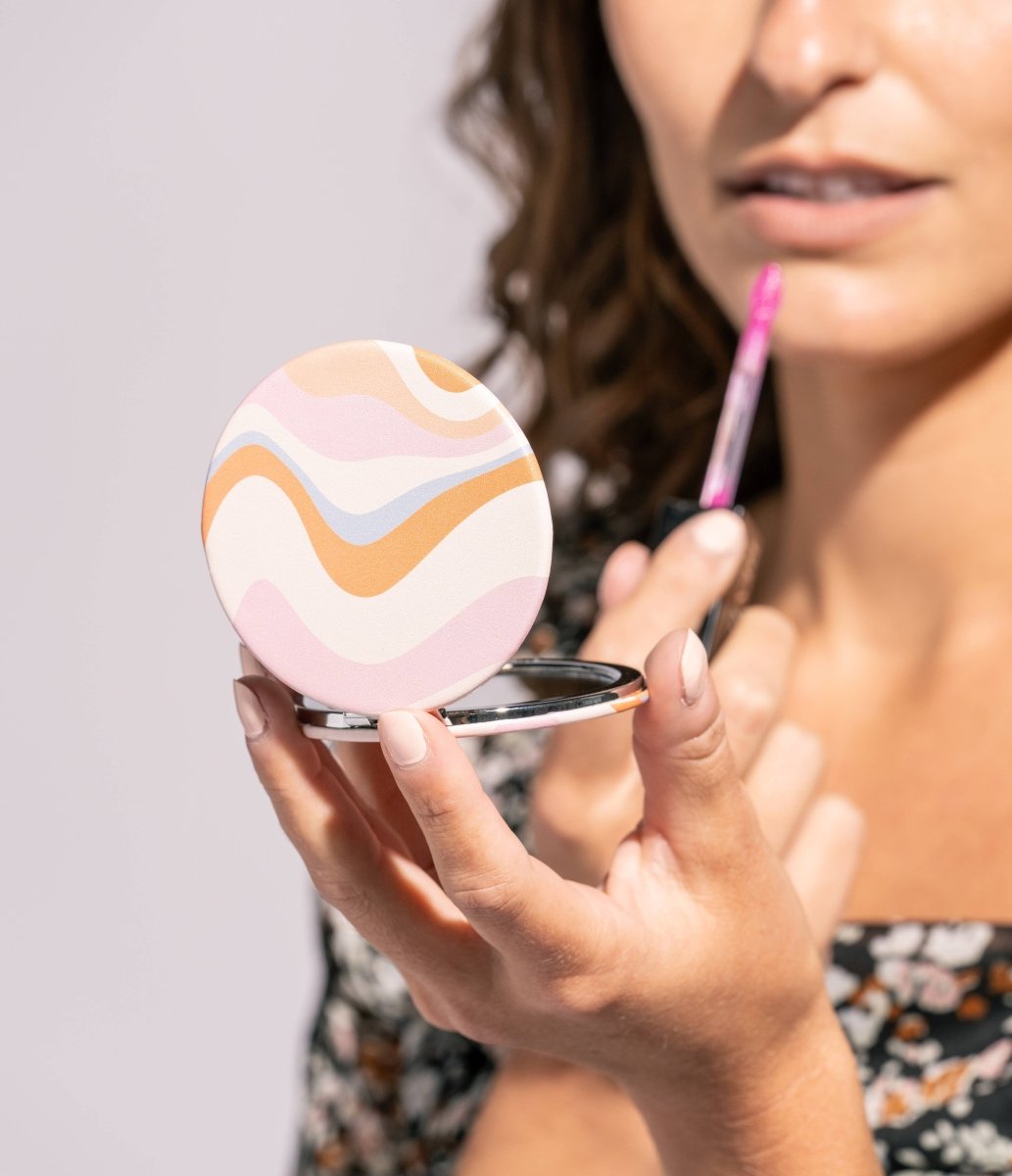 A round Crush I Feel Seen compact mirror with printed design
