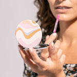 A round Crush I Feel Seen compact mirror with printed design