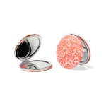 A round Crush I Feel Seen compact mirror with printed design