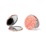 A round Crush I Feel Seen compact mirror with printed design