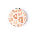 A round Crush I Feel Seen compact mirror with printed design