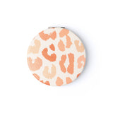 A round Crush I Feel Seen compact mirror with printed design