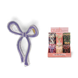 A large bow-shaped Crush Very Demure hair clip