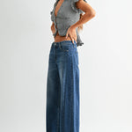 Dark wash wide leg jeans with a raw hem finish