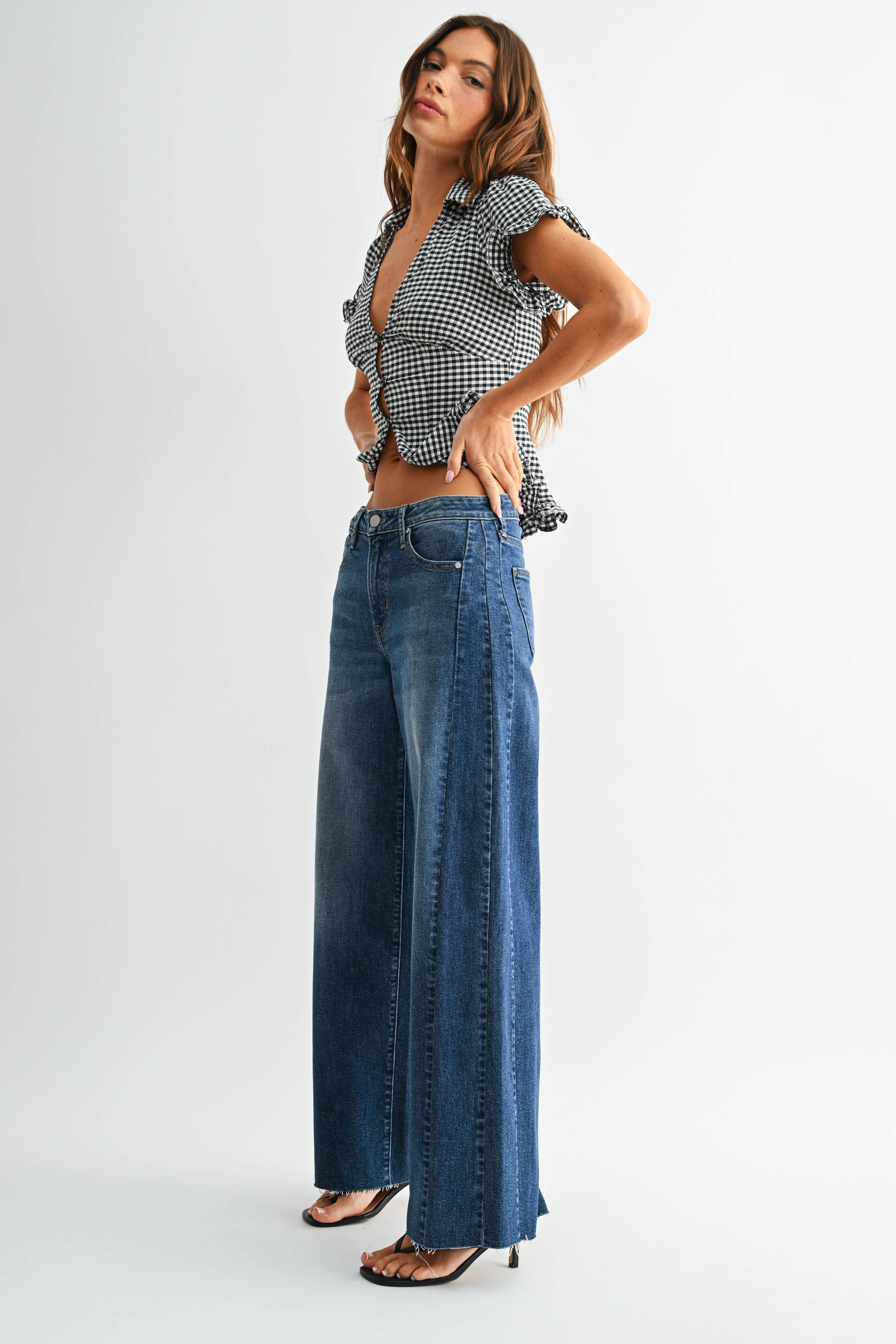 Dark wash wide leg jeans with a raw hem finish