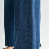 Dark wash wide leg jeans with a raw hem finish