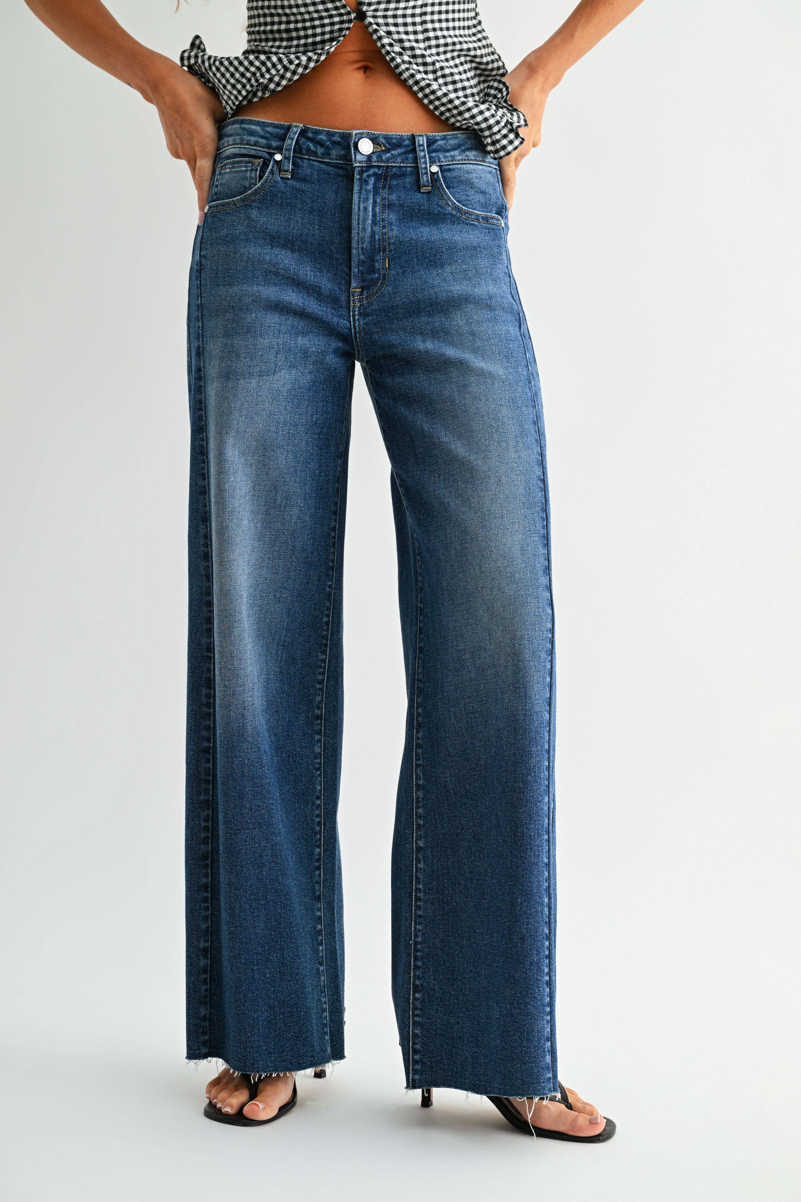 Dark wash wide leg jeans with a raw hem finish